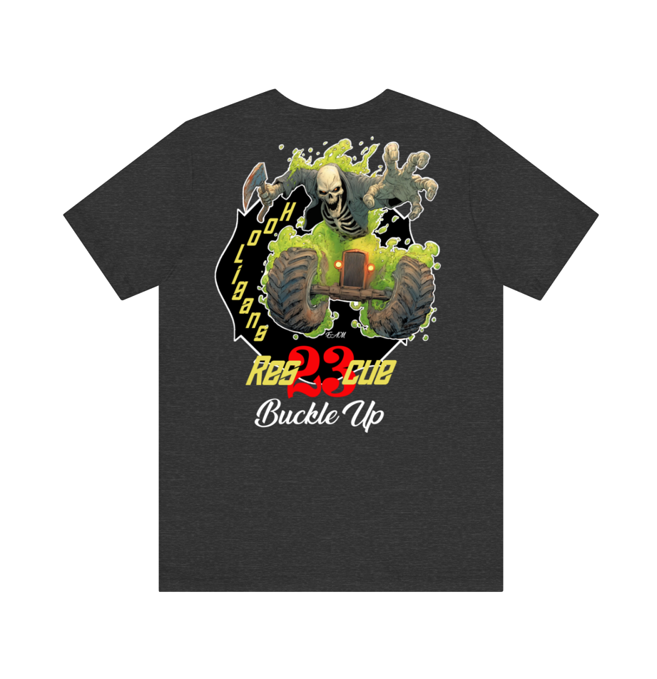 A dark heather gray t-shirt featuring a large graphic print on the front. The graphic depicts a skeleton riding a green buggy with a skull in its mouth, set against a black background with yellow and red text that reads 'Buckle Up'.