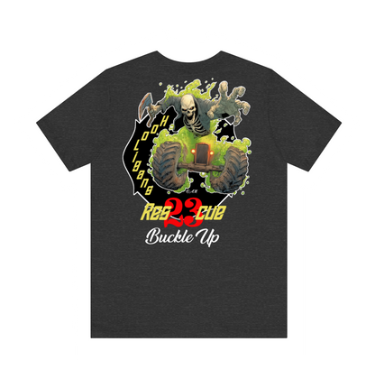 A dark heather gray t-shirt featuring a large graphic print on the front. The graphic depicts a skeleton riding a green buggy with a skull in its mouth, set against a black background with yellow and red text that reads 'Buckle Up'.