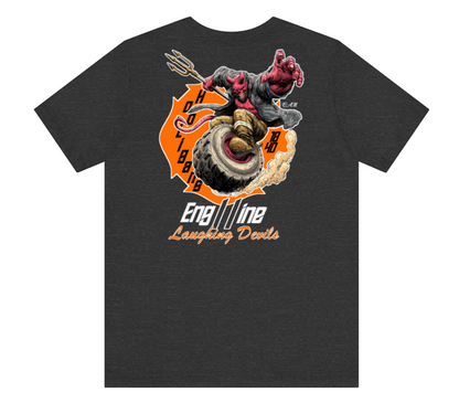 A dark heather gray t-shirt featuring a large graphic print on the front. The graphic depicts a devil-like character with a trident riding a tire, set against an orange circular background with the text 'H O C T O B 1988' and 'Engine Laughing Devils' written below.