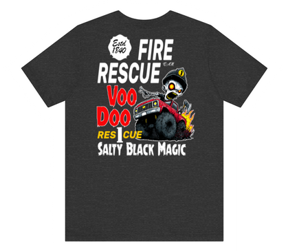 A dark heather gray t-shirt with a humorous graphic print on the front. The graphic features a cartoon zombie driver in a red fire truck with flames, surrounded by text reading 'FIRE RESCUE', 'VOO DOO', 'RES CUE', and 'SALTY BLACK MAGIC'.