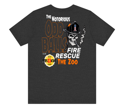 A dark heather gray t-shirt featuring a graphic print of a skull wearing a firefighter helmet and smoking a cigar, with text reading 'The Notorious Odd Balls Fire Rescue The Zoo'.